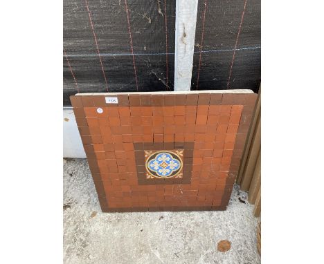 A SQUARE CONCRETE TABLE TOP WITH MOSAIC TILE DECORATION 