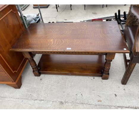 AN OAK COFFEE TABLE WITH LOWER SHELF 