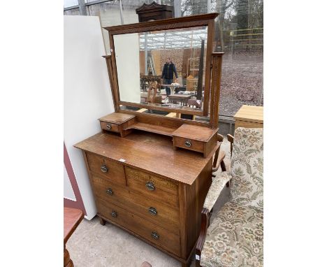 AN OAK ART NOUVEAU DRESSING CHEST OF TWO SHORT AND TWO LONG DRAWERS, THE MIRROR TOP ENCLOSING TWO JEWELLERY DRAWERS, 39" WIDE