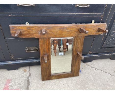AN EARLY 20TH CENTURY OAK WALL MOUNTED MIRROR WITH FOUR COAT HOOKS, 49x44x22" 
