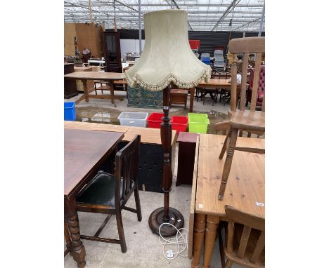 A MAHOGANY STANDARD LAMP ON TURNED AND FLUTED COLUMN COMPLETE WITH SHADE 