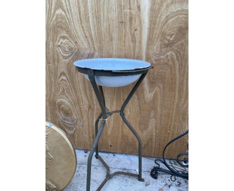 A VINTAGE ENAMEL WASH BASIN ON A WROUGHT IRON STAND 