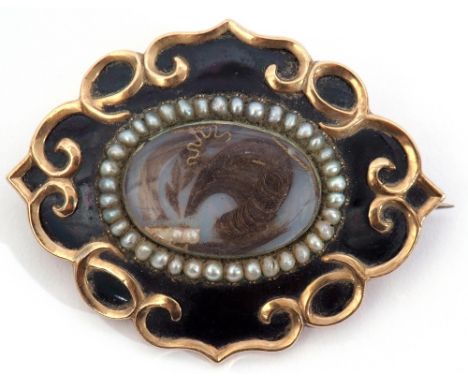 Victorian mourning brooch, the glaze centre with lock of hair, small seed pearls and a gold thread, all within a surround of 