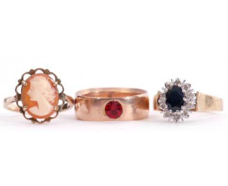 Mixed Lot: 9ct gold wide band ring set with a red stone, a 9ct stamped cameo ring, together with a 9ct paste set ring, gross 