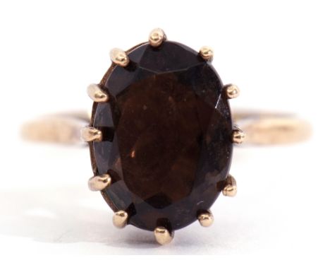 9ct gold smokey quartz ring of oval faceted shape, multi-claw set to a high basket collet, gross weight 3gms