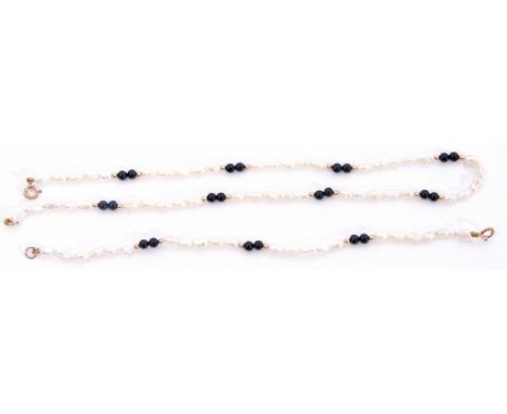 Matching necklace and bracelet of white freshwater cultured pearls interspersed by pairs of black onyx spherical beads to a y