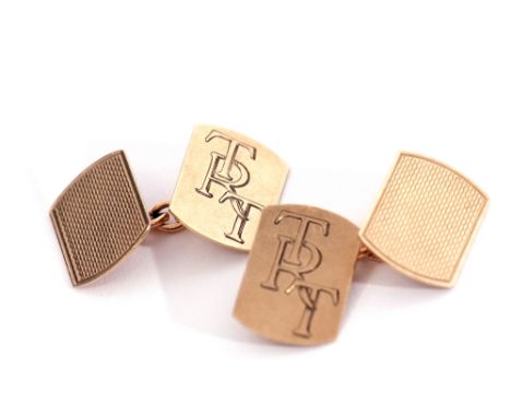 Pair of 9ct gold cuff links of rectangular shaped form, one side engraved with entwined initials, TRT, the other engine turne