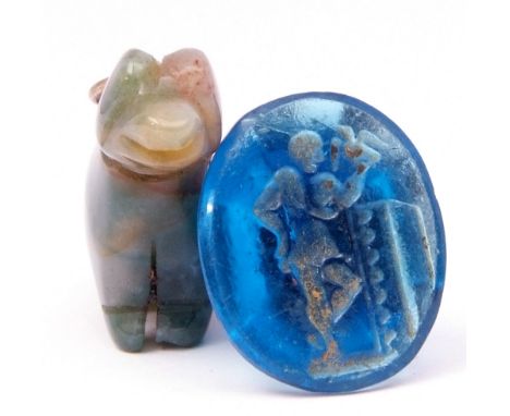 Mixed Lot: vintage jade pendant carved as a seated dog, together with an antique blue glass intaglio seal, the matrix carved 
