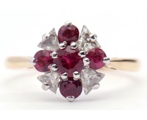 Diamond and ruby cluster ring featuring 4 round graduated rubies interspersed with 4 trillion cut diamonds, stamped 18ct and 