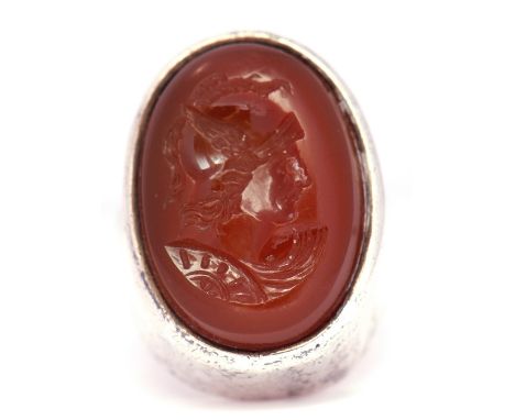 White metal framed intaglio ring, the oval hard stone reverse carved with a profile of a centurion, size K