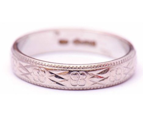 Platinum wedding ring, chased and engraved with a continuous geometric design, size M, 4.5gms