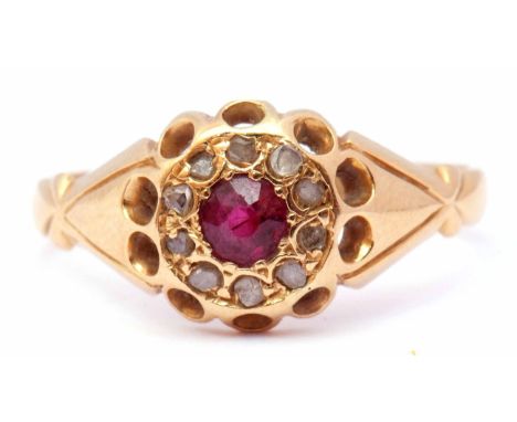 Early 20th century 18ct gold ruby and diamond ring, centring a round faceted ruby within a surround of small old cut diamonds