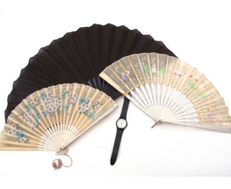 Mixed Lot: two vintage hand decorated fans, both with card spines, a black linen-fold fan (a/f) together with a Swatch quartz