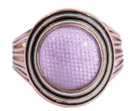 Georgian ring, the oval glazed pink silk panel framed within two bands of black and white enamel, the enclosed back engraved 