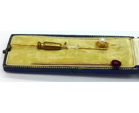 A boxed yellow metal and pearl stick pin and another stick pin