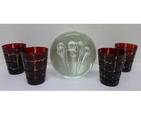 A large glass paperweight and four ruby glasses