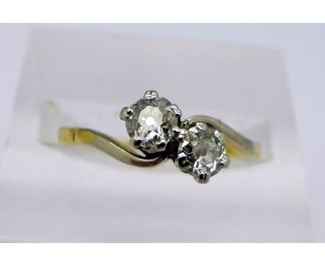 A c1920's 18ct gold and platinum two diamond cross over ring, approximately 0.7ct diamond weight, old cut diamonds, total wei