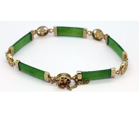 A yellow metal and jade bracelet