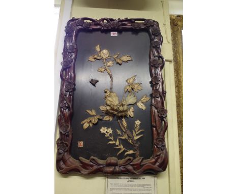A Japanese carved wood framed bone and lacquer panel, 70cm high x 40cm wide.&nbsp; 