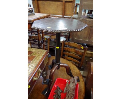 An unusual stained and ebonized octagonal tripod table, with novelty boot form feet, 43.5cm wide. 