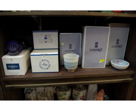 A small collection of boxed ceramics, to include examples by Royal Copenhagen, Lladro and Caithness. 