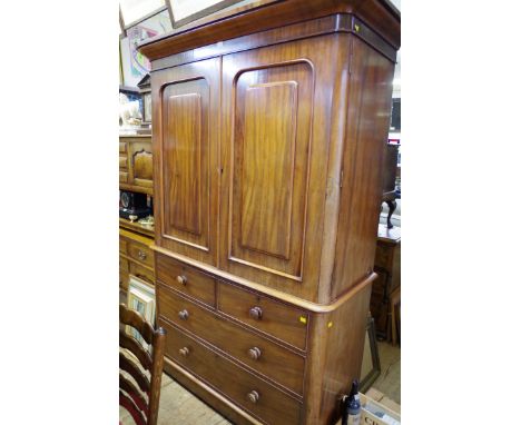A Victorian mahogany linen press, the pair of fielded panel doors enclosing four replacement mahogany trays, 138.5cm wide. 