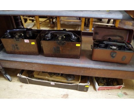 Two 1930s/40s German field telephones, each in brown bakelite case; together with another GPO example.&nbsp; 