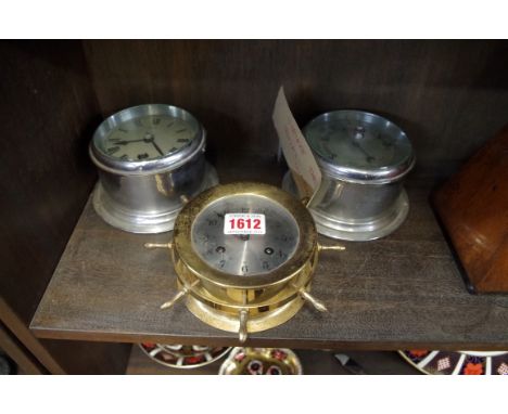 A Sestrel bulkhead clock and aneroid barometer set; together with a Schatz brass ships wheel timepiece. 