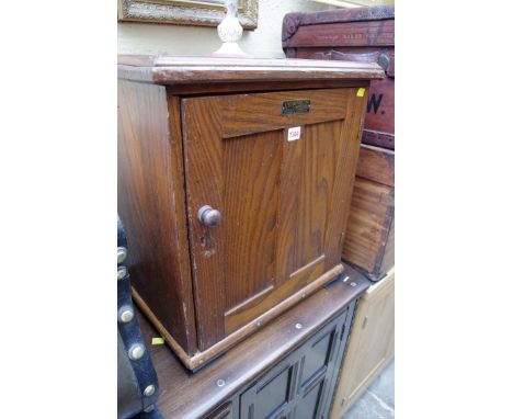 An American oak slide storage cabinet, inscribed 'Keystone View Company, Meadville, PA', panel door enclosing an arrangement 