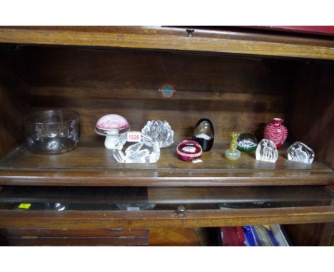 A collection of English and Continental clear and coloured glass paperweights and similar, to include examples by Wedgwood; O