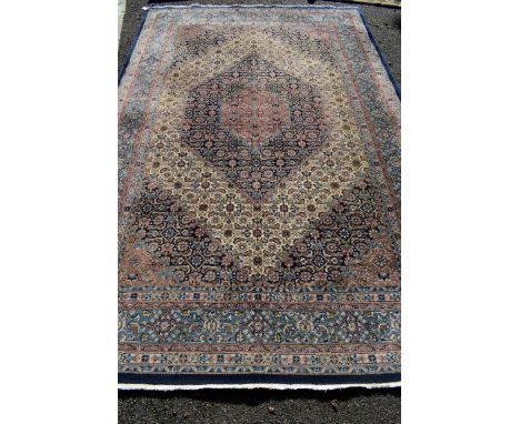 An Eastern carpet, having allover floral and geometric design with central diamond field, 310 x 200cm. 