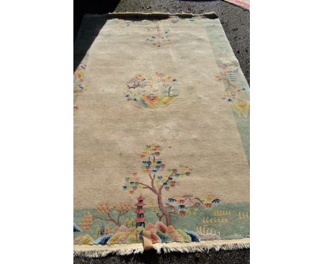 A Chinese carpet, having cream central field with central medallion and tree design, 274 x 183cm. 