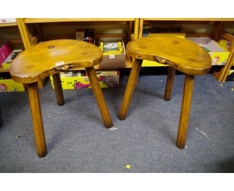 A pair of 'Mouseman' style oak tripod stools,&nbsp;each 37cm wide.&nbsp; 