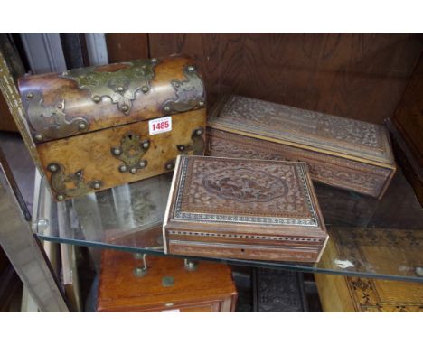 A Victorian burr walnut and brass strapwork domed top tea caddy, 23cm wide; together with an Indian carved hardwood glove typ