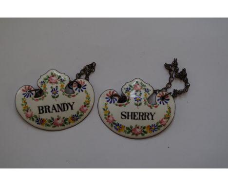 A pair of enamel decanter labels, for brandy and cherry. 