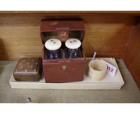 A vintage leather cased pair of silver and ivory mounted clear glass scent bottles, the case inscribed 'Asprey, London'; toge