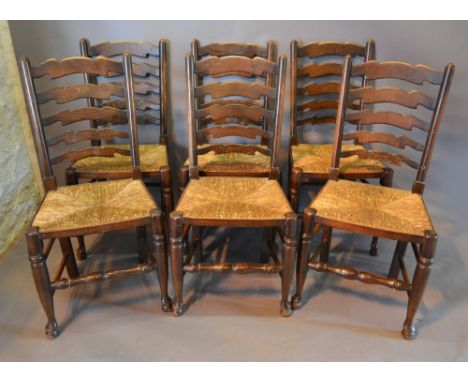 A Set of Six Country Ladder Back Dining Chairs with Rush Seats and Turned Legs with Pad Feet