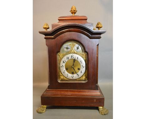 A 19th Century Mahogany Large Bracket Clock with gilt metal pineapple finials and brass paw feet, the dial with silvered chap