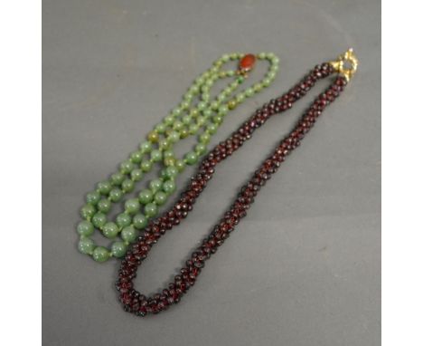 A Jade Bead Necklace together with another similar garnet necklace