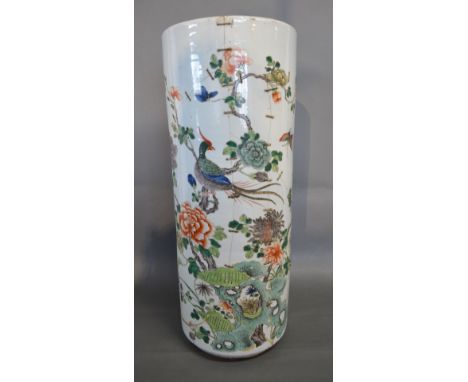 A Late 19th Early 20th Century Chinese Porcelain Stick Stand decorated in polychrome enamels with a peacock amongst foliage, 