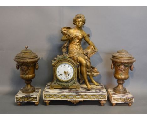 A 19th Century French Gilded Three Piece Clock Garniture, the clock with figure surmount and enamel dial with Arabic numerals