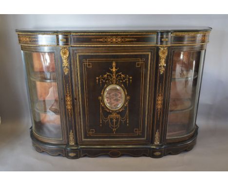 A Victorian Ebonised Marquetry Inlaid and Gilt Metal Mounted Credenza Cabinet, the central door with an oval bevelled mirror 