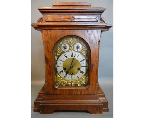 A 19th Century Oak Cased Large Bracket Clock, the brass dial with silvered chapter ring with Roman numerals and strike silent