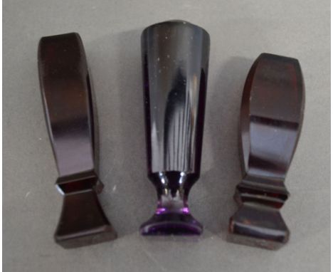A Ruby Glass Seal together with two other similar