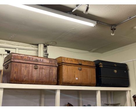 Three vintage tin trunks.