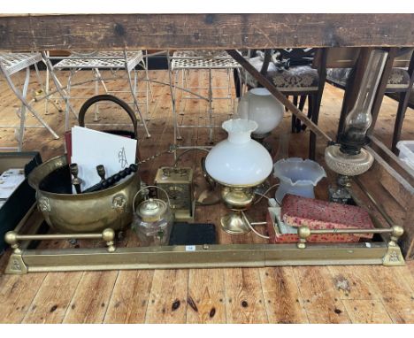 Collection of oil lamps, brass fender, coal bucket and scuttle, mantel clock, cigarette cards, etc.