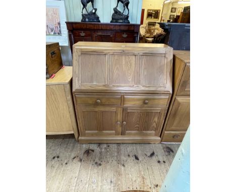 Ercol Golden Dawn bureau, the fall front above two drawers and two cupboard doors, 108cm by 93.5cm by 44cm.