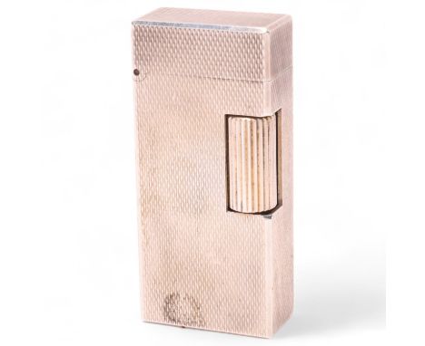 A vintage Dunhill silver plated Rollagas lighter, engine tuned body, makers marks to base No 50230, length 5.2cmSurface marks