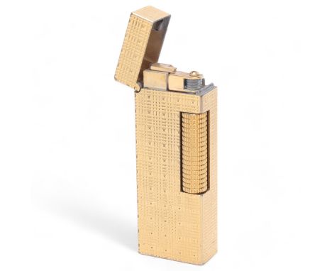 A vintage Dunhill Rollagas gold plated lighter, textured body, makers marks to base, length 6.3cmSome surface marks, rubbing,