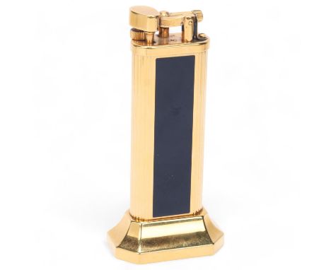 A vintage Dunhill gold plated table lighter, with black lacquer panels, makers marks to base, No 23932, height 10cmGood condi